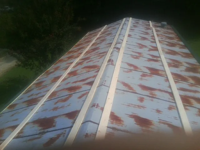 Rusted metal roof panels with new wood purlins before replacement — Storm Damage Roof Repair in Bradley by Roofing Brothers